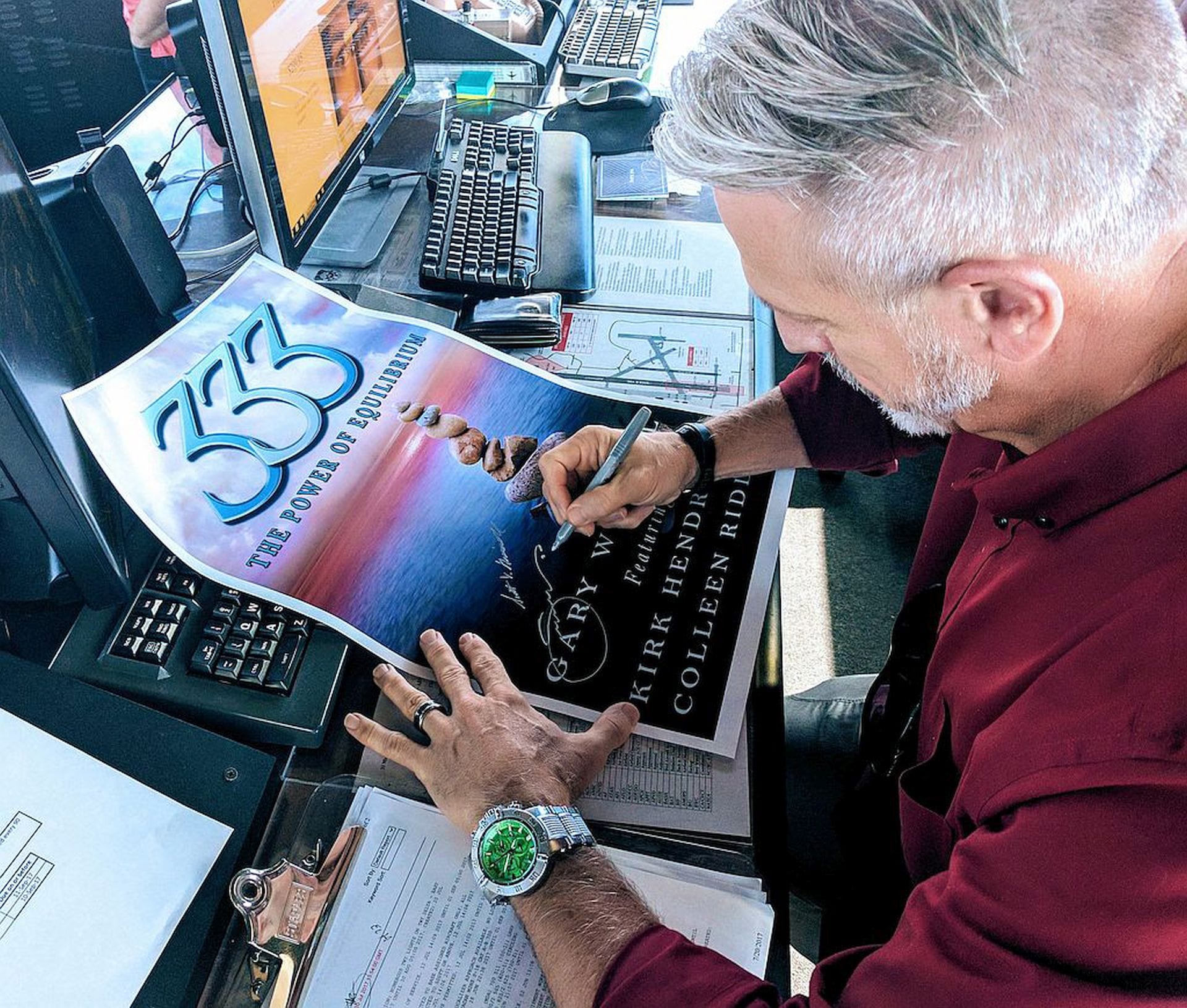 Gary signing a poster for his book: 333