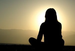 Silhouette of a woman sitting down