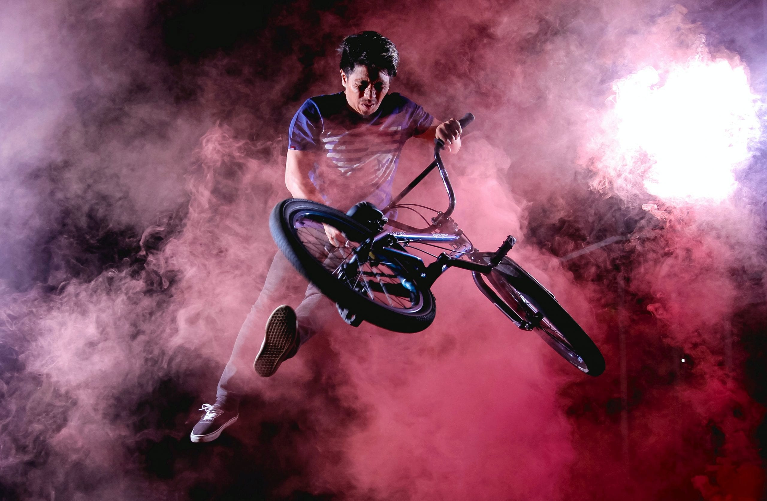 Bicycle rider in mid-air in the midst of a smokescreen